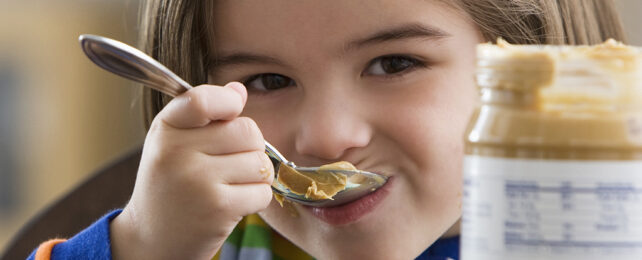 Boy eating peanut butter